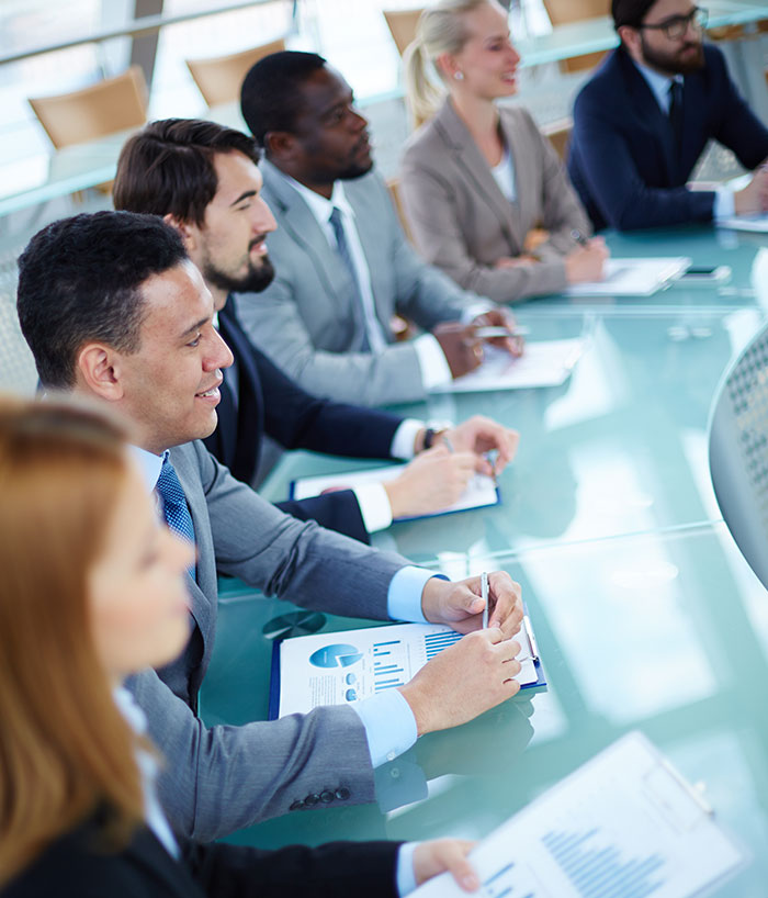 Six business owners are seated at a table together at a focus group meeting