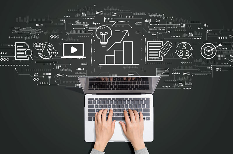 A person's hands type on the keyboard of a laptop computer with a variety of symbols floating above it representing digital marketing and lead generation