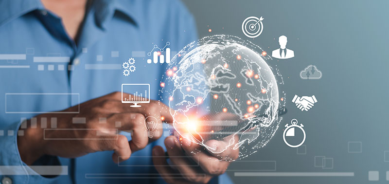 A person holds the image of the Earth with different symbols on it representing successful international prospecting and lead generation