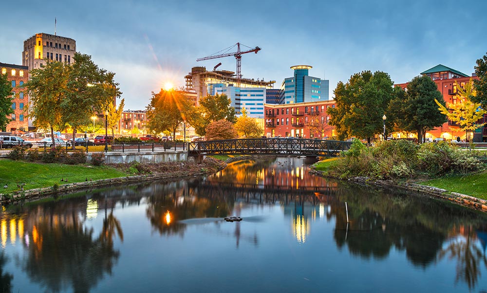 Old and new buildings next to a scenic pond in Kalamazoo, Michigan