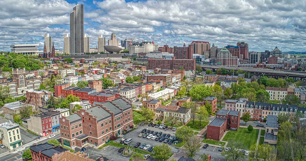 Aerial photo of the city of Albany, New York, showing various residential and commercial buildings and skyscrapers