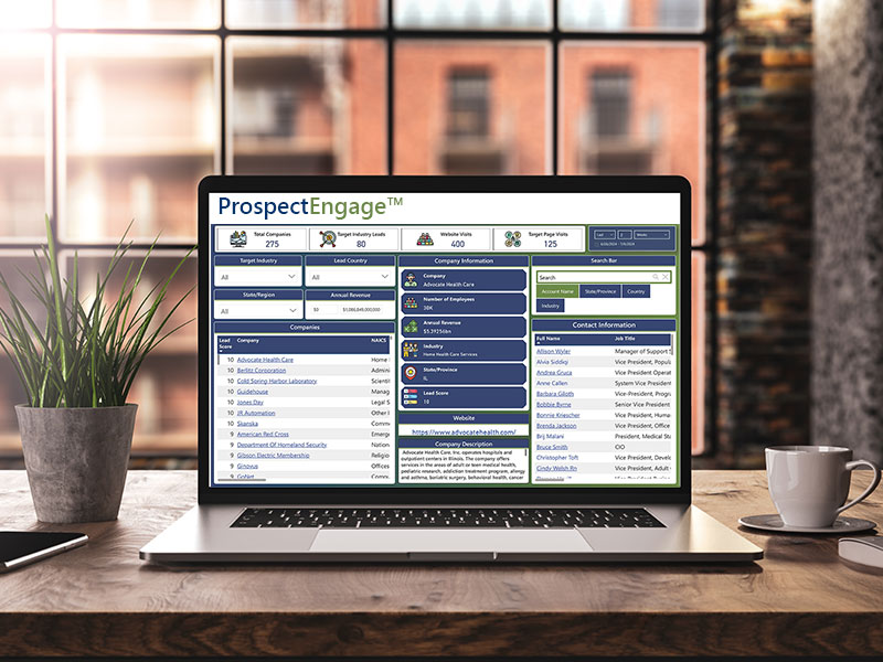 An open laptop sits on an office desk with the main ProspectEngage dashboard showing