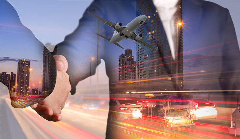 A man and woman shake hands with the images of a passenger jet landing in a city and freeway traffic